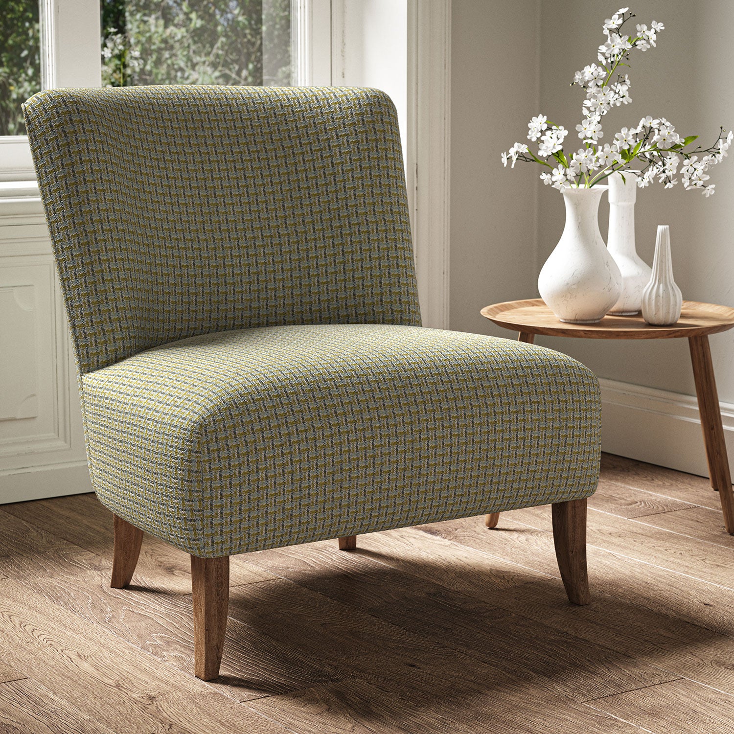 Armchair in a printed linen fabric with textural weave pattern in blue and yellow colours.