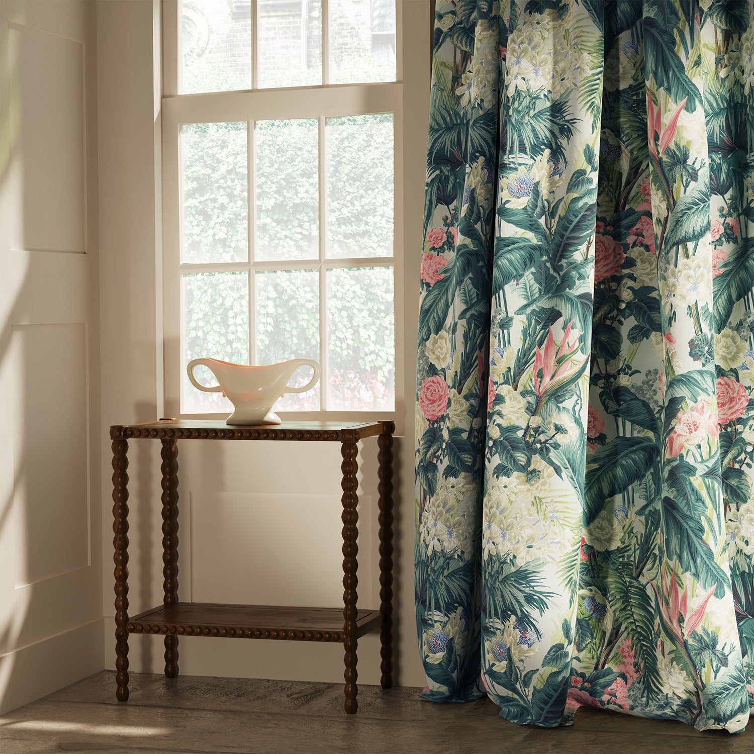 Curtain in a light coloured tropical floral linen fabric