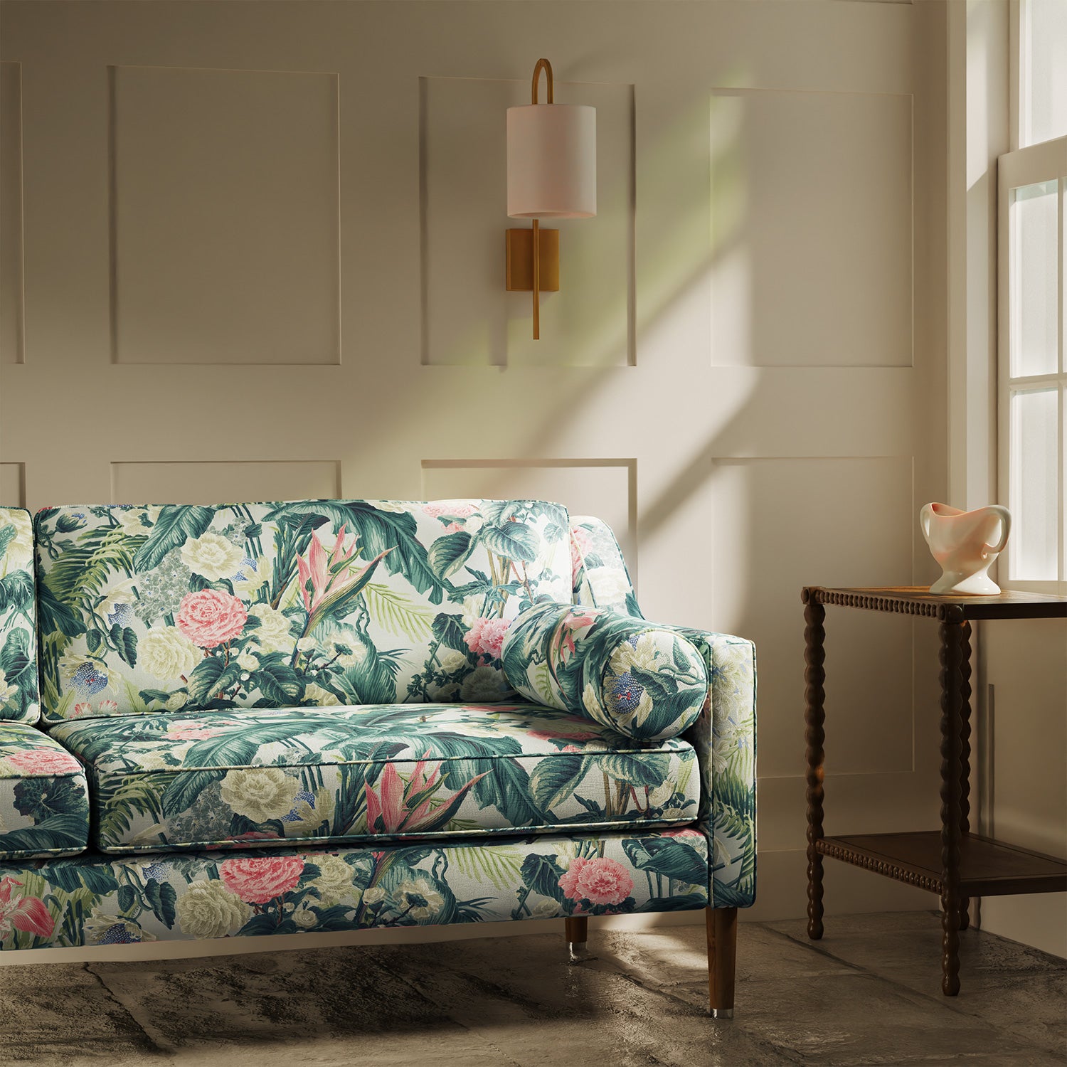 Sofa upholstered in a light coloured tropical floral linen fabric