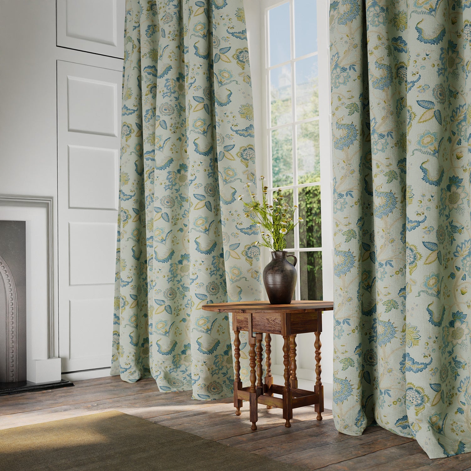 Curtains in a printed linen fabric with tree of life design in blue and green colours.