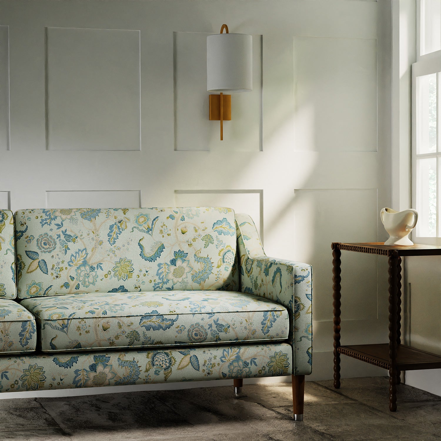 Sofa in a printed linen fabric with tree of life design in blue and green colours.