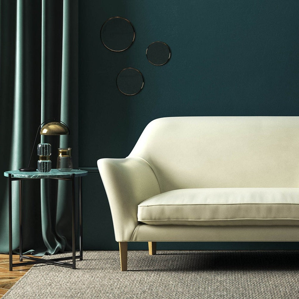 Sofa covered in a cream velvet upholstery fabric