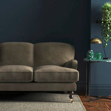 Sofa covered in a brown velvet upholstery fabric