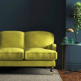 Sofa covered in a yellow velvet upholstery fabric