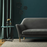 Sofa covered in a grey velvet upholstery fabric