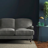Sofa covered in a grey velvet upholstery fabric