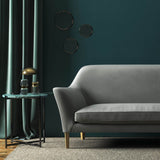 Sofa covered in a grey velvet upholstery fabric