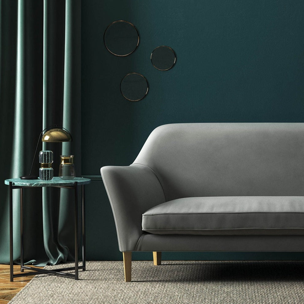 Sofa covered in a grey velvet upholstery fabric