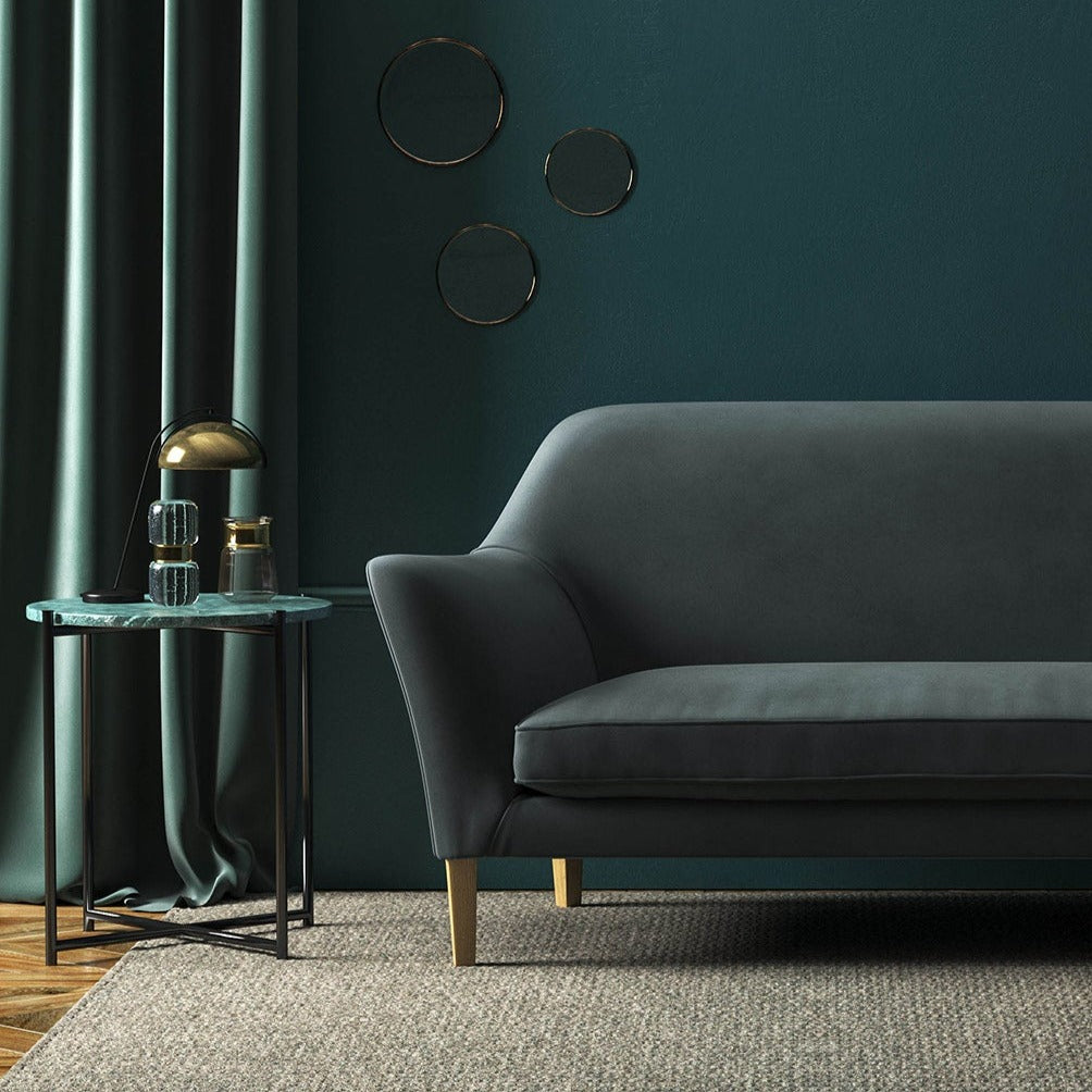 Sofa covered in a grey velvet upholstery fabric