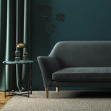 Sofa covered in a grey velvet upholstery fabric
