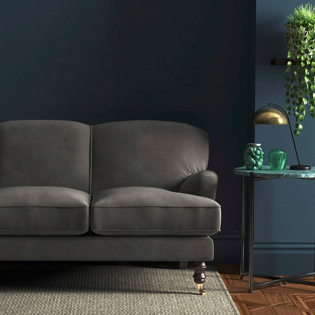 Sofa covered in a grey velvet upholstery fabric