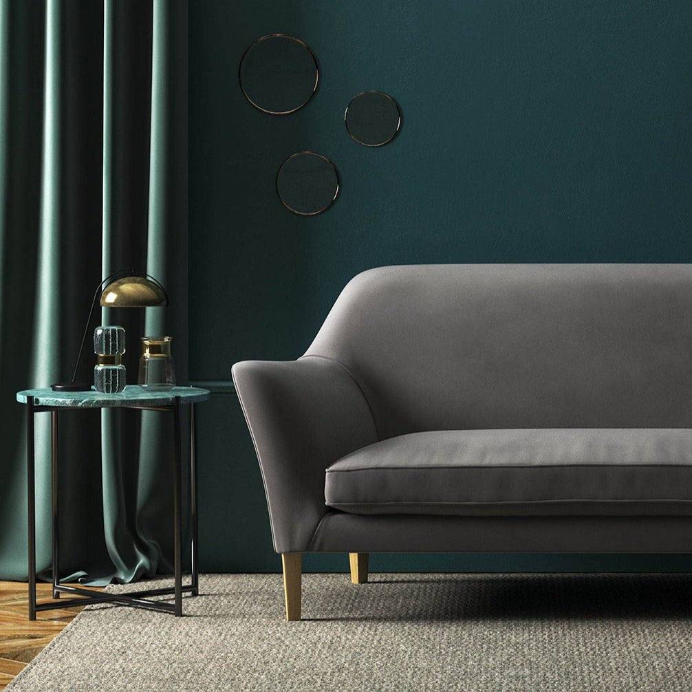 Sofa covered in a grey velvet upholstery fabric