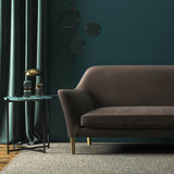 Sofa covered in a brown velvet upholstery fabric
