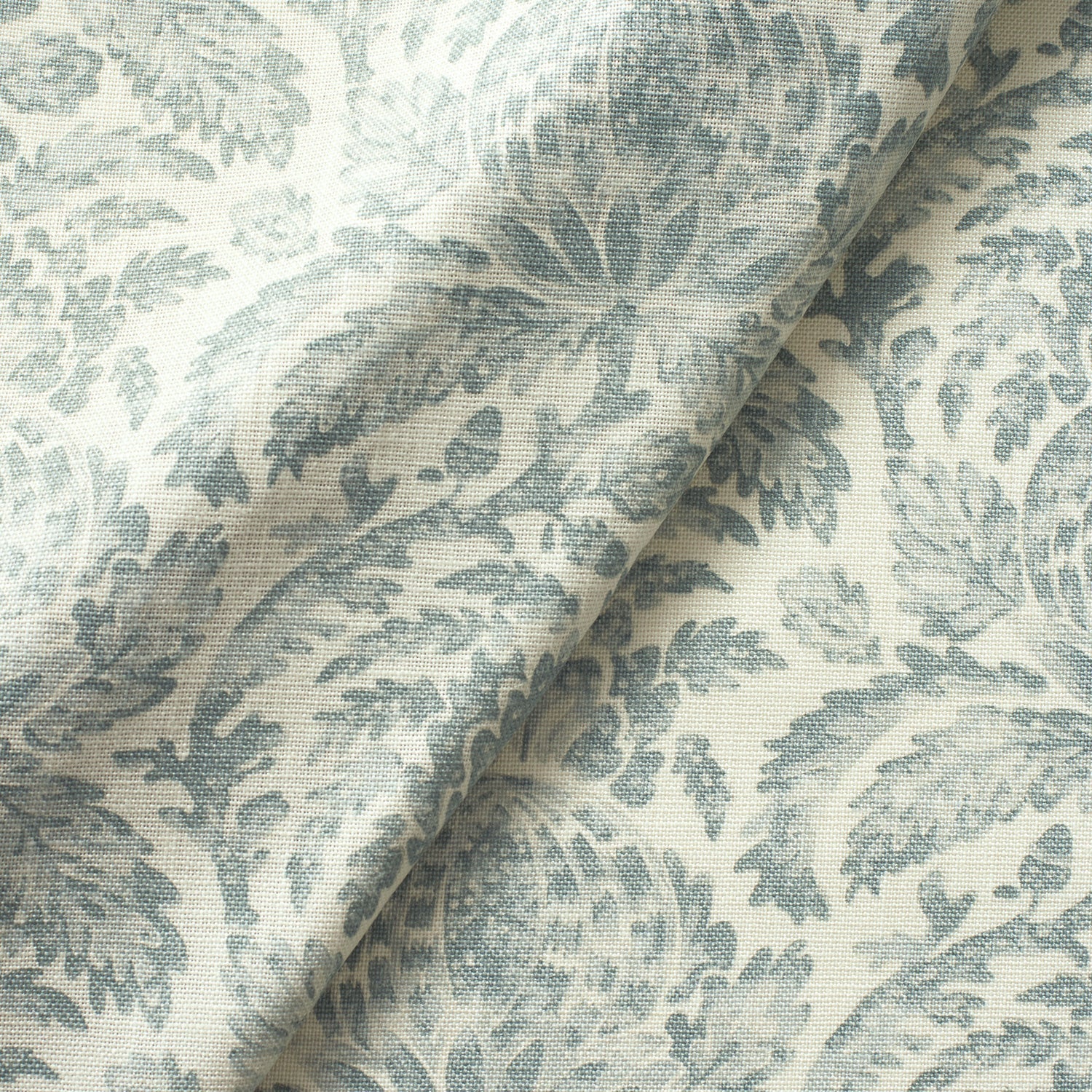 Fabric swatch of a dusky blue vintage inspired floral and leaf design fabric for curtains and upholstery