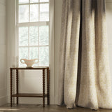 Curtains in a classic light yellow floral and leaf fabric