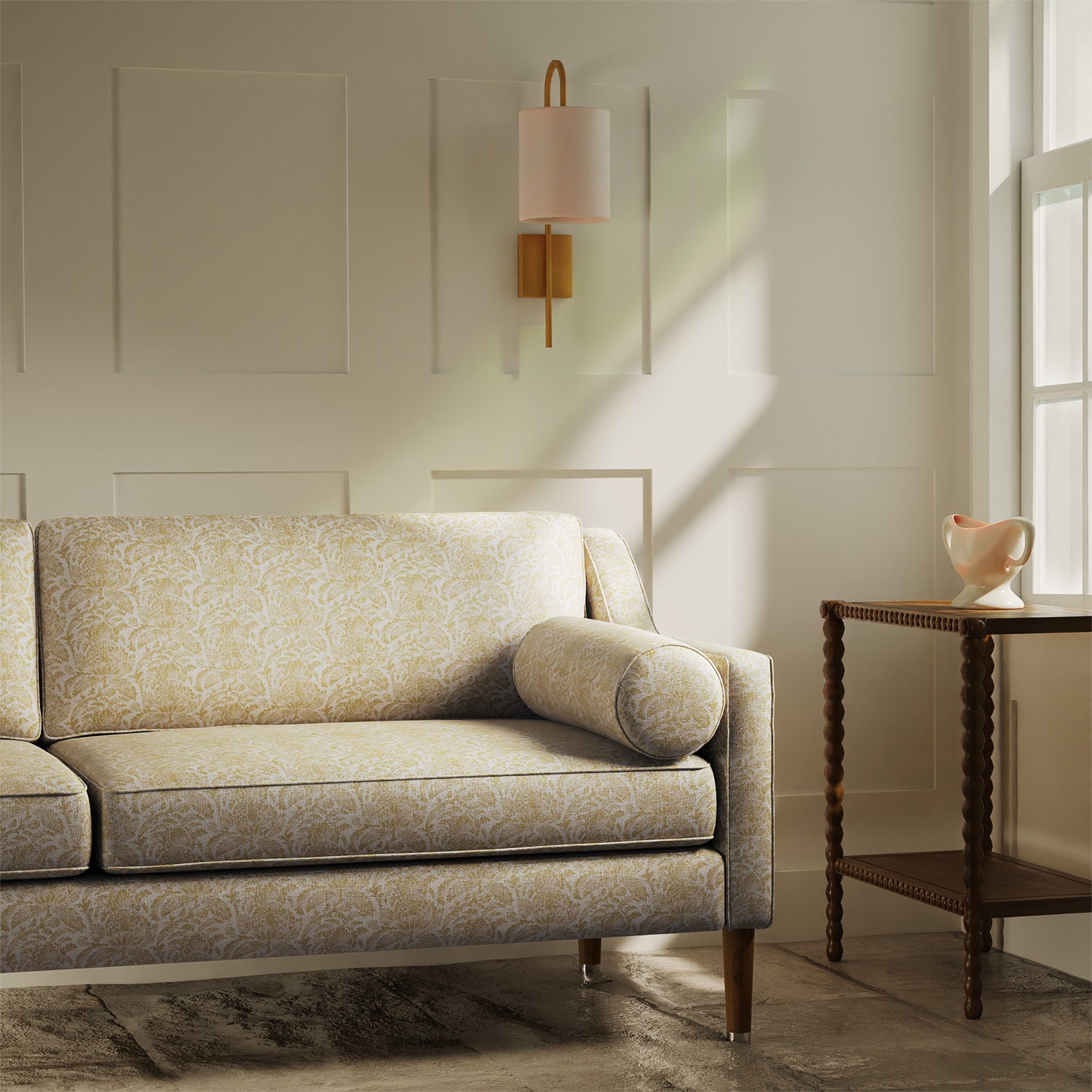 Sofa upholstered in a luxury light yellow floral and leaf fabric