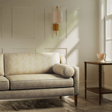 Sofa upholstered in a luxury light yellow floral and leaf fabric