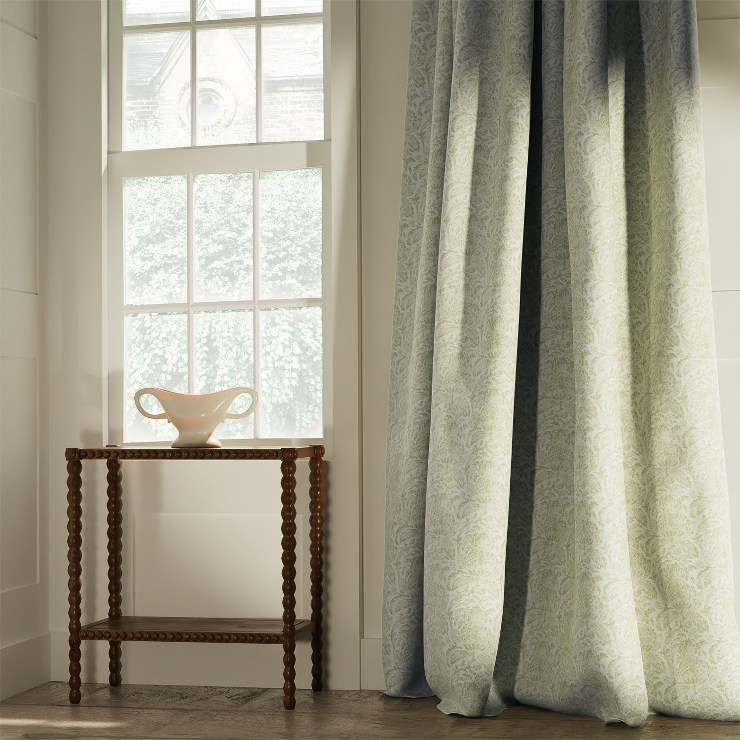 Curtains in a classic light green floral and leaf fabric