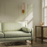 Sofa upholstered in a luxury light green floral and leaf fabric