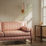 Sofa upholstered in a luxury light red floral and leaf fabric