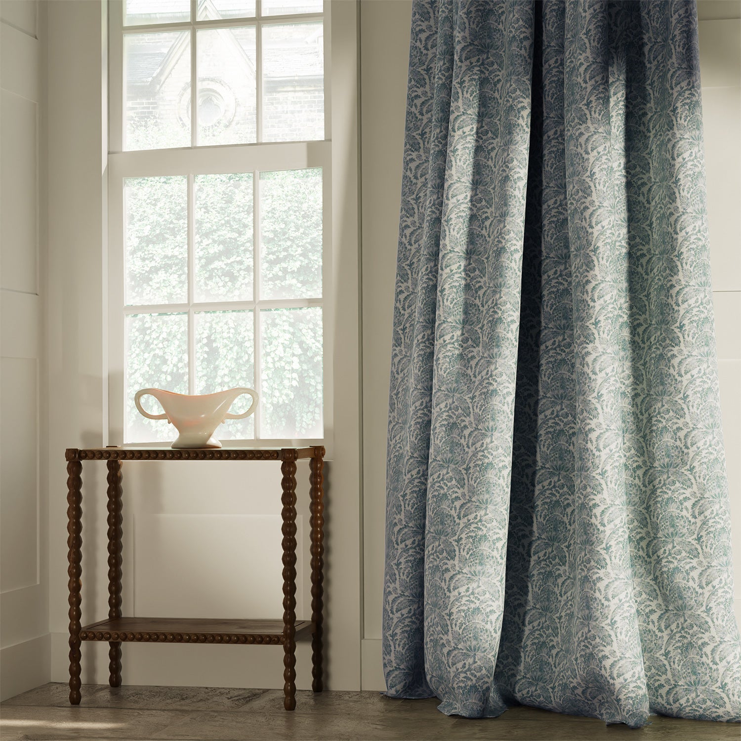 Curtains in a classic dusky blue floral and leaf fabric