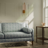 Sofa upholstered in a luxury dusky blue floral and leaf fabric