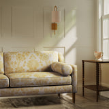 Sofa upholstered in a luxury yellow floral damask fabric