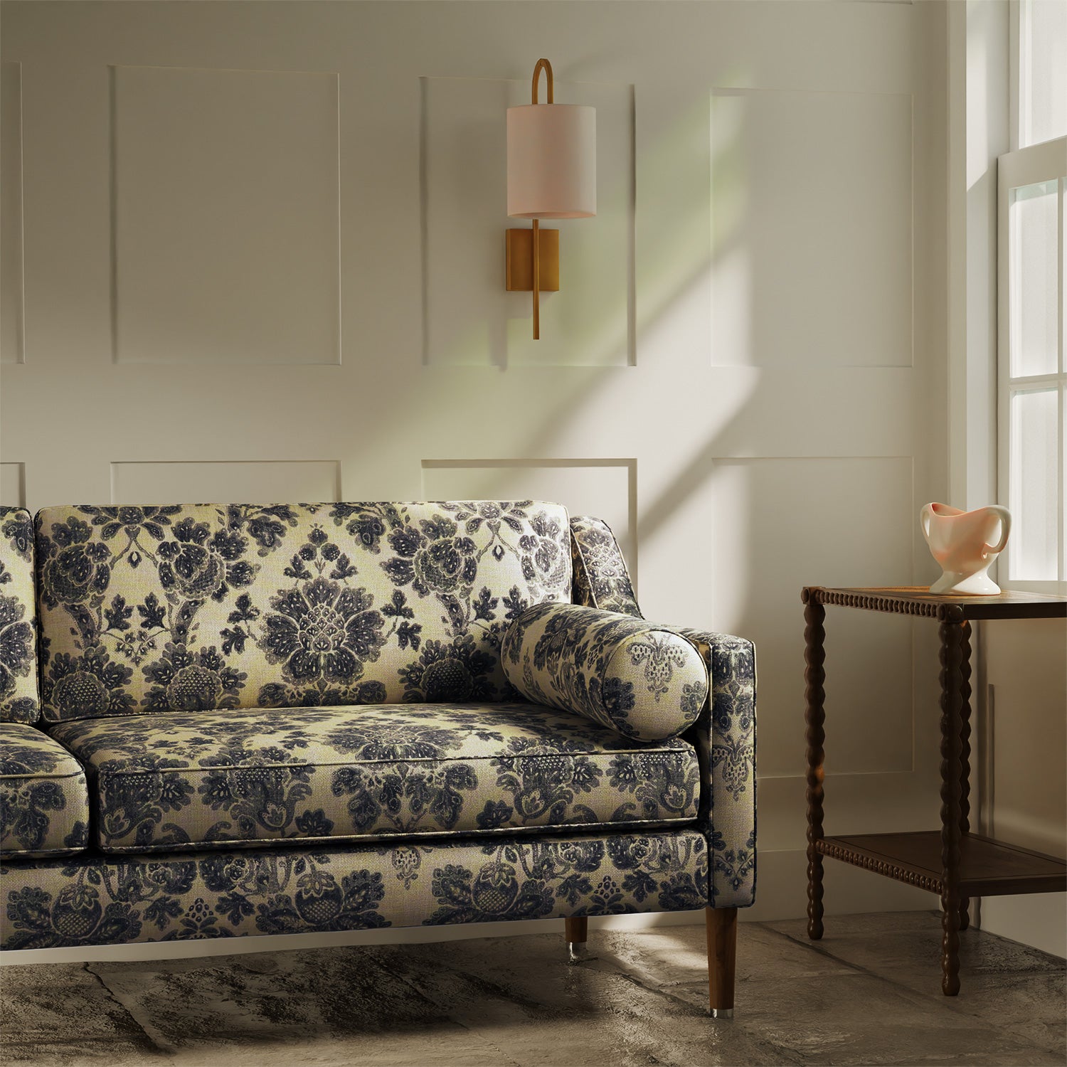 Sofa upholstered in a luxury beige and dark grey floral damask fabric
