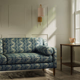 Sofa upholstered in a navy floral fabric with stripe design
