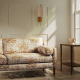Sofa upholstered in a luxury neutral and yellow floral bouquet fabric