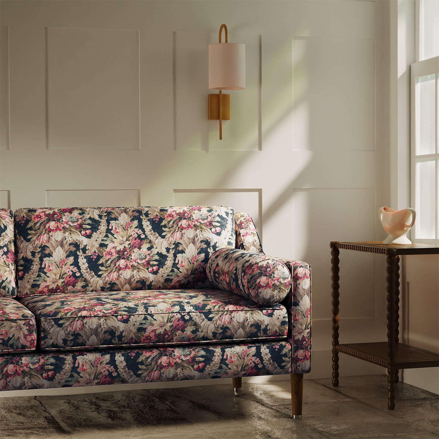 Sofa upholstered in a luxury dark blue and pink floral bouquet fabric