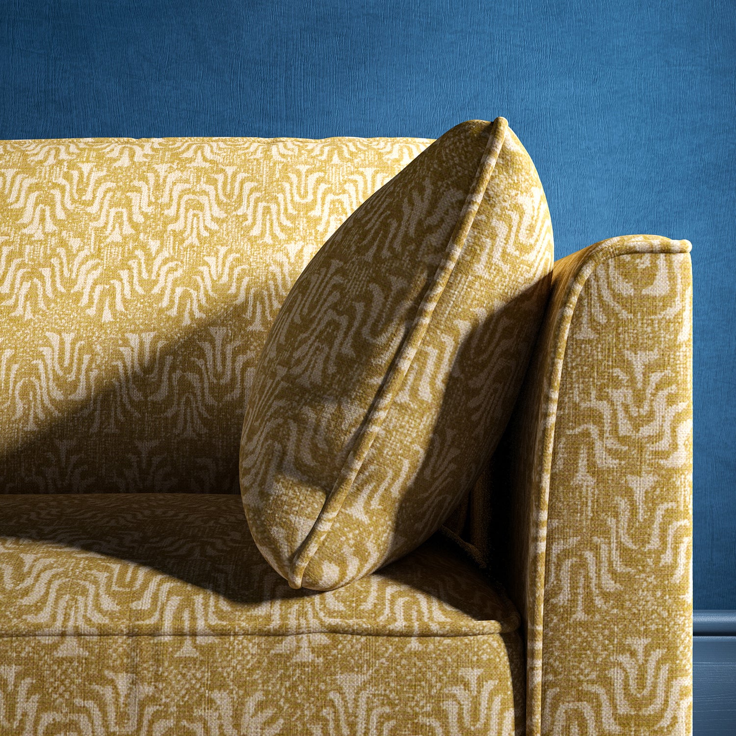 Sofa upholstered in a yellow and neutral jacquard weave upholstery fabric