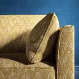 Sofa upholstered in a yellow and neutral jacquard weave upholstery fabric