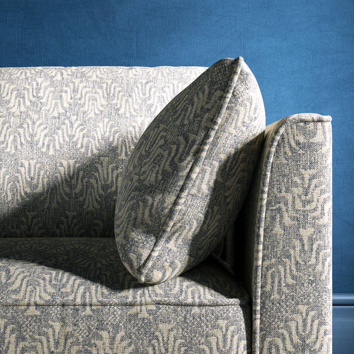 Sofa upholstered in a light blue and neutral jacquard weave upholstery fabric