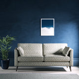Sofa upholstered in a light blue and neutral jacquard weave upholstery fabric