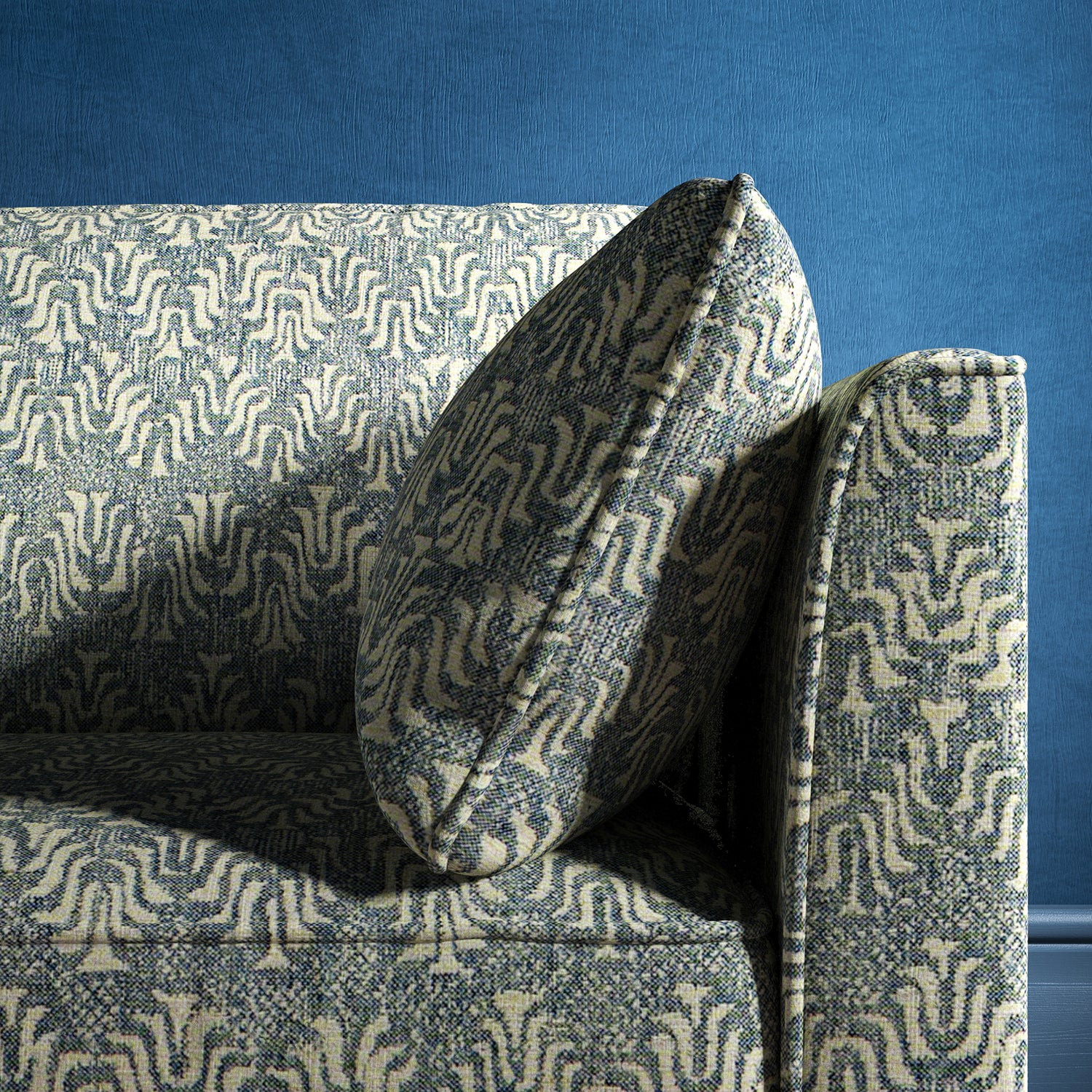 Sofa upholstered in a blue and neutral jacquard weave upholstery fabric