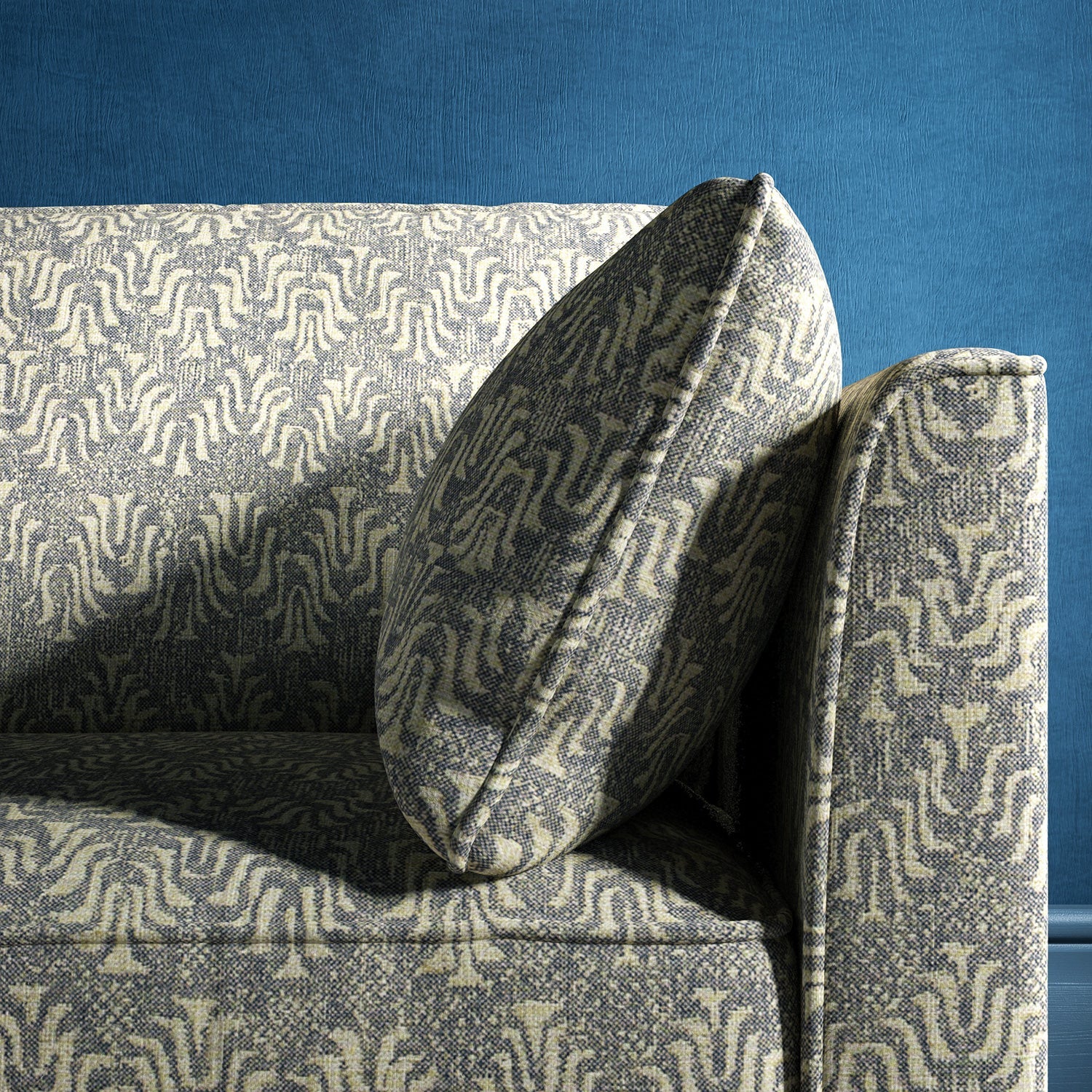 Sofa upholstered in a dark blue and neutral jacquard weave upholstery fabric