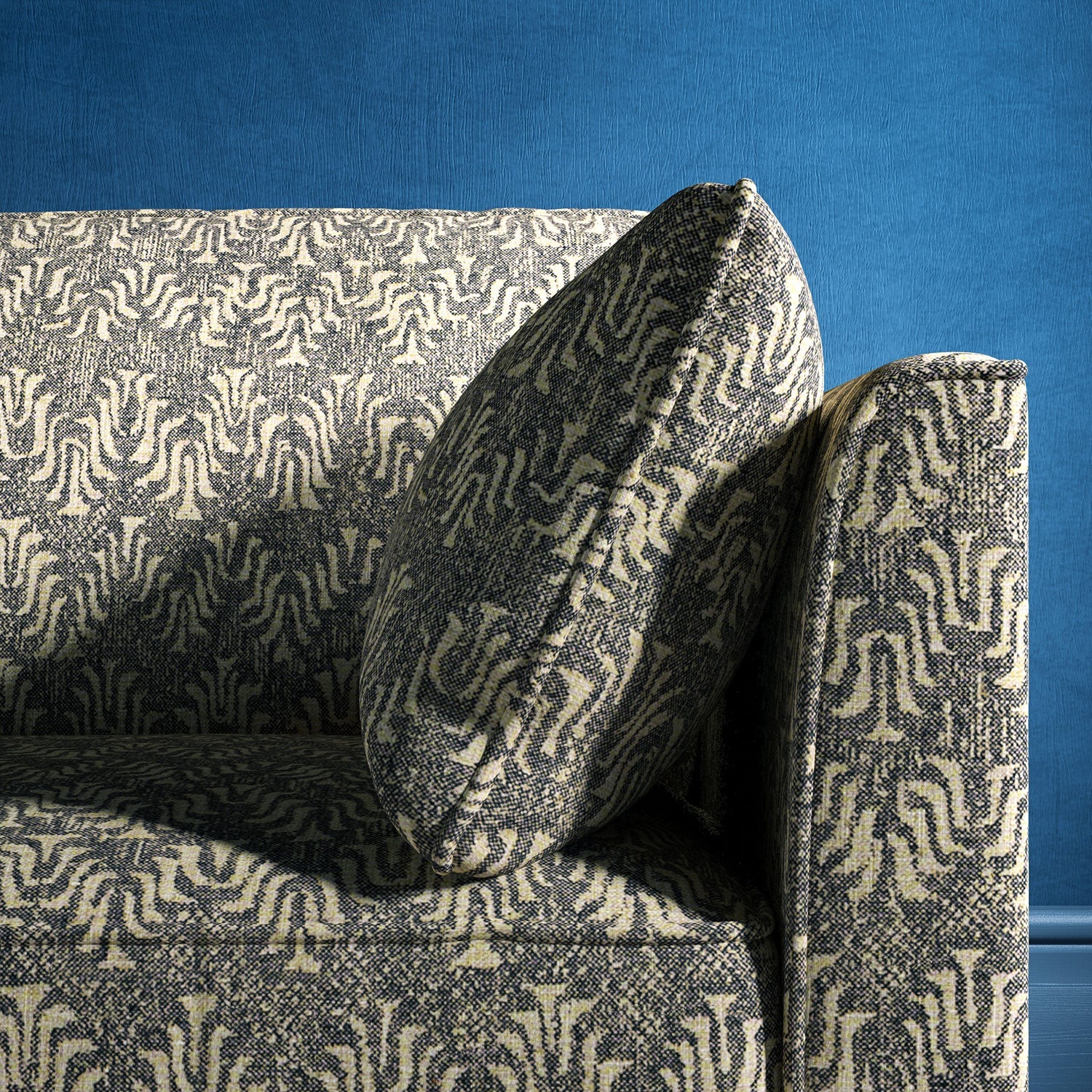 Sofa upholstered in a dark grey and neutral jacquard weave upholstery fabric