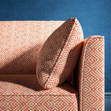 Sofa upholstered in a pink and neutral geometric weave upholstery fabric