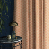 Curtains in a orange and white geometric weave fabric