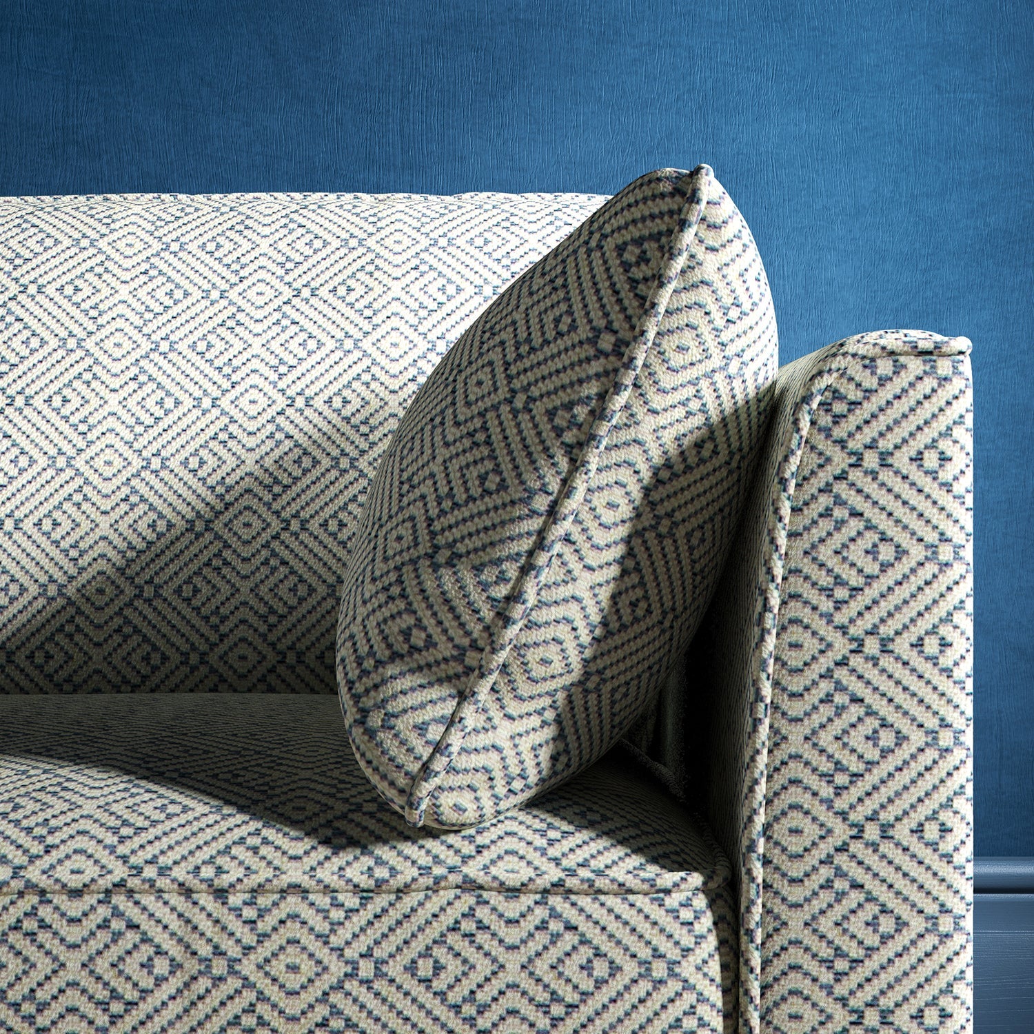 Sofa upholstered in a sky blue and neutral geometric weave upholstery fabric
