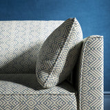 Sofa upholstered in a sky blue and neutral geometric weave upholstery fabric