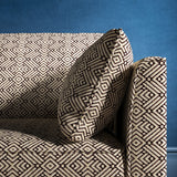 Sofa upholstered in a monochrome geometric weave upholstery fabric