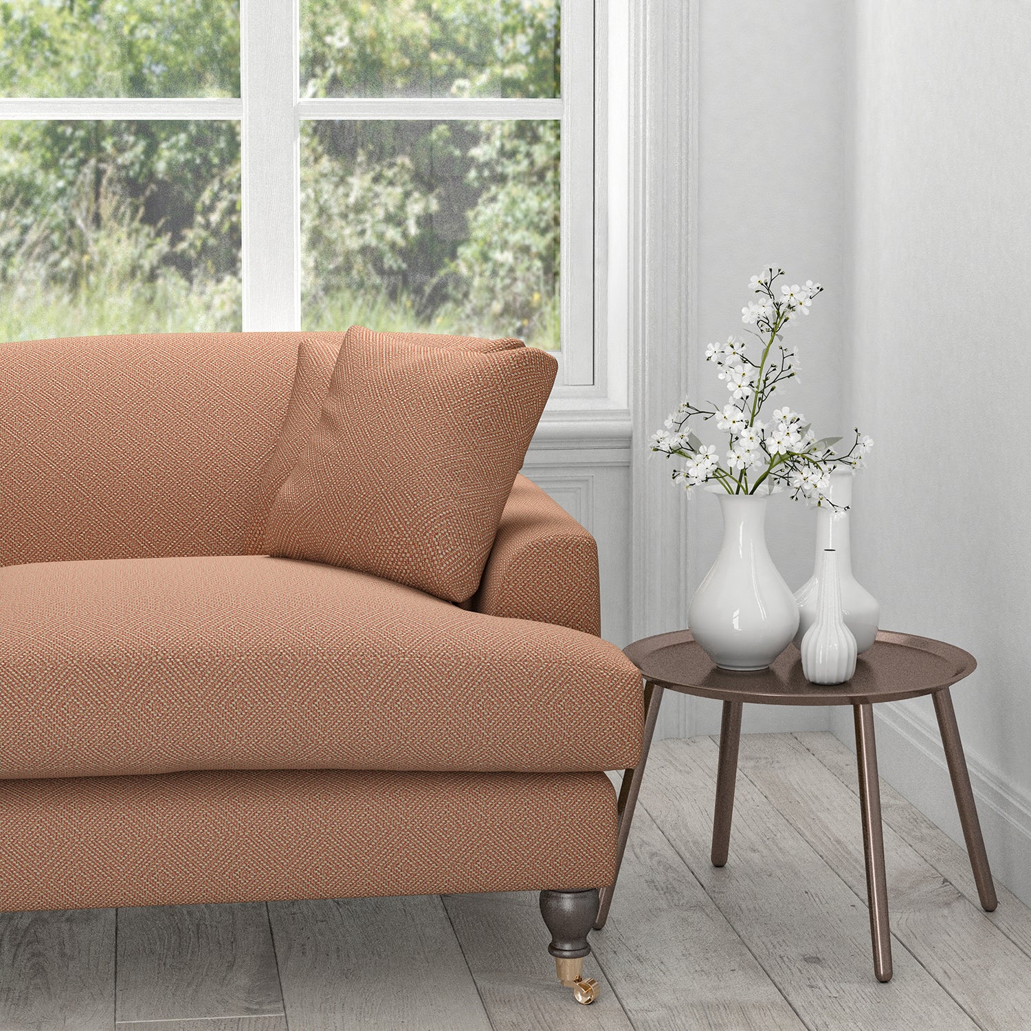 Sofa upholstered in a orange fabric with a light woven geometric design