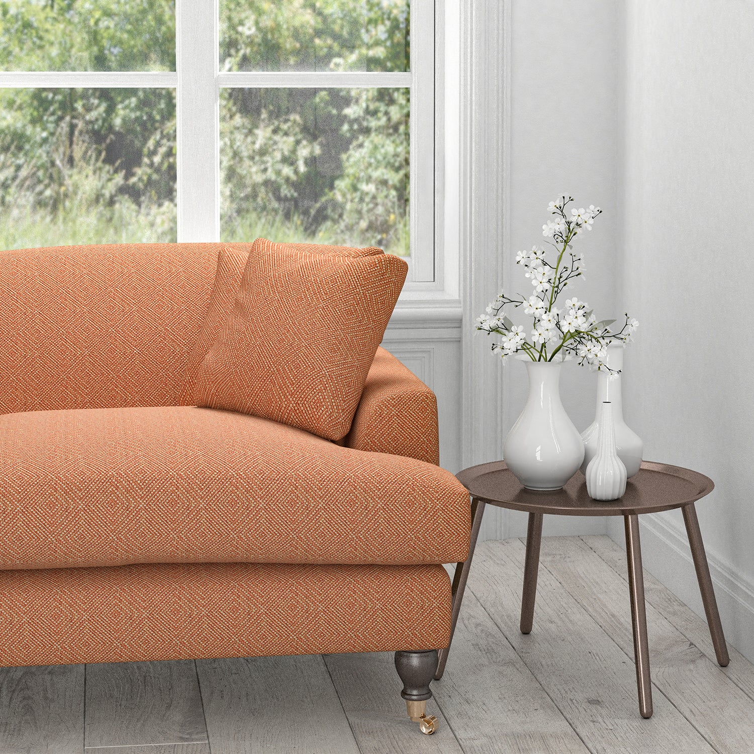 Sofa in an orange fabric with a neutral woven geometric design