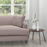 Sofa in a purple upholstery fabric with a light woven geometric design