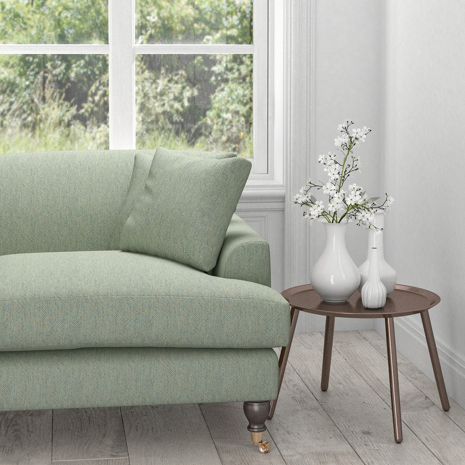 Sofa upholstered in a light blue fabric with a woven geometric design