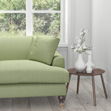 Sofa in a light green upholstery fabric with a neutral woven geometric design