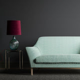 Sofa in a light blue and white wavy weave fabric.