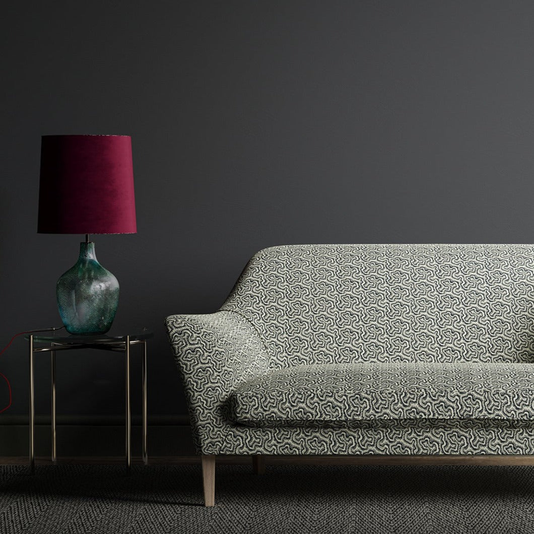 Sofa upholstered in a monochrome wavy geometric weave fabric.